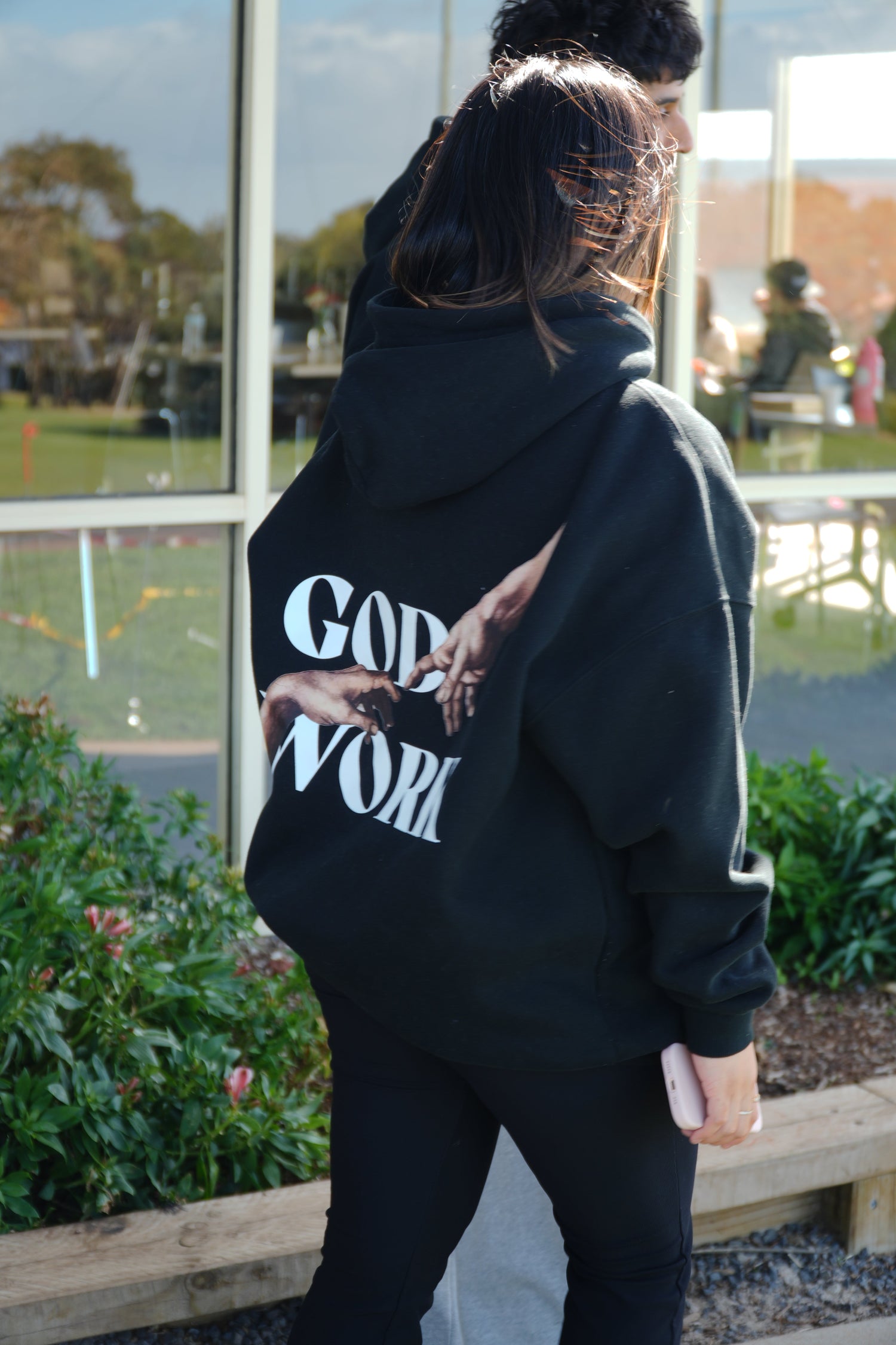 “Black oversized hoodie and matching pants set with bold Christian message ‘Jesus Saves – Always Saves’ printed on the front. Minimalist, luxury streetwear style designed as a reminder of faith, hope, and comfort.”